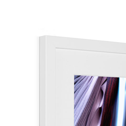 A white picture frame has a view of two close-up pictures on it.
