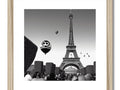 An art print with an image of a large balloon flying over Paris.