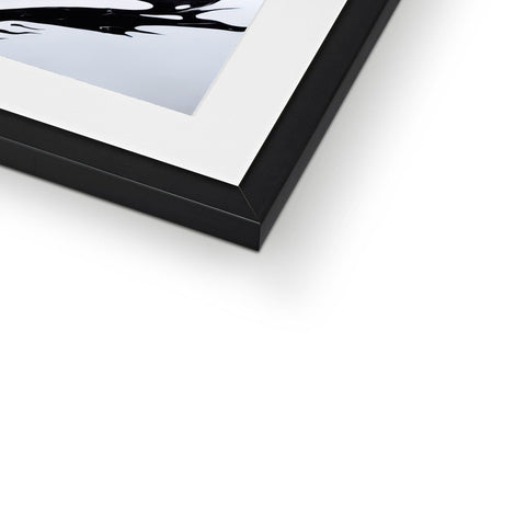 A frame with a white photo of an image on top of a book.