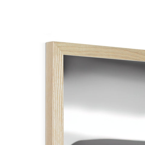 A wooden frame holding items on top of a flat glass table.