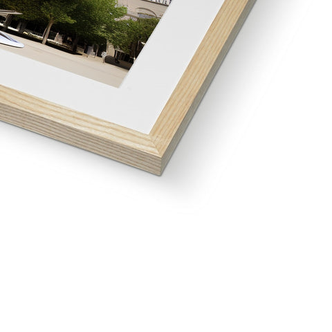 A picture frame displaying a framed picture sitting on a wall of a tree next to a