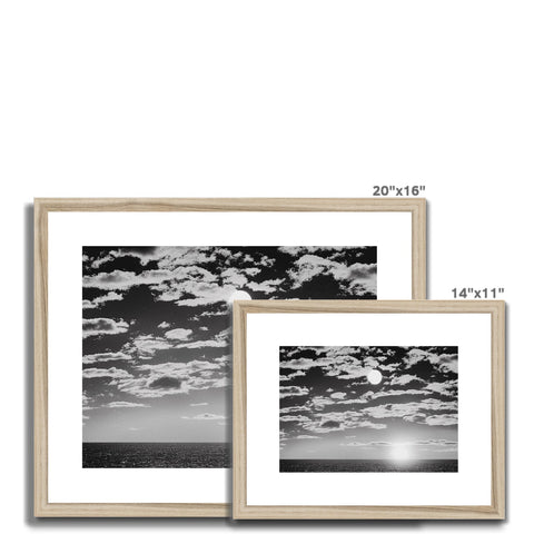 A picture frame with a black and white image of photo of the sun outside on a