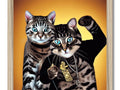 Two cats are shown with gold backgrounds on two pictures inside of a gold framed frame.