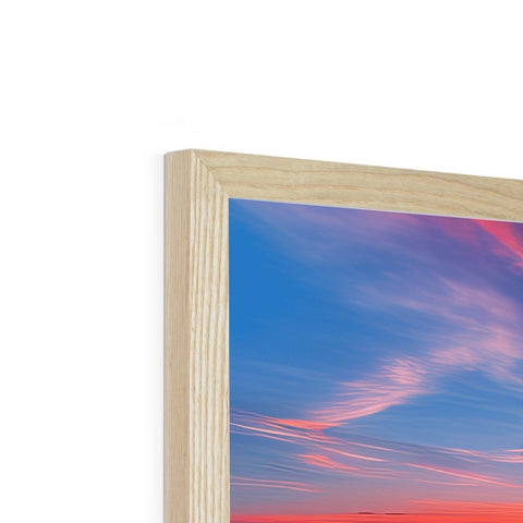 A picture frame holding three photos with a frame containing the sun and wood framed art on