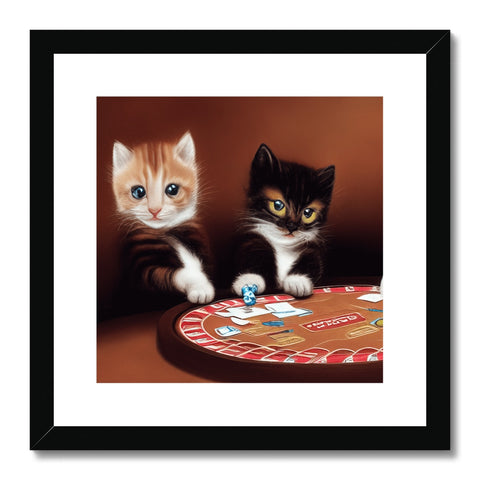 Two cats holding an art print while watching a white cat play.