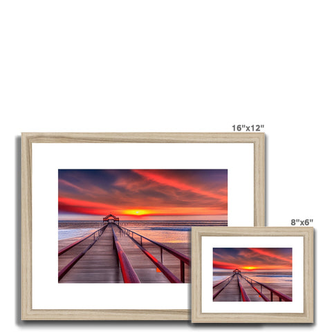 White picture frames with two images sitting side by side on a table.