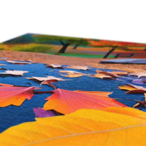 Fall leaves on a white cloth table covered in colorful card cards.