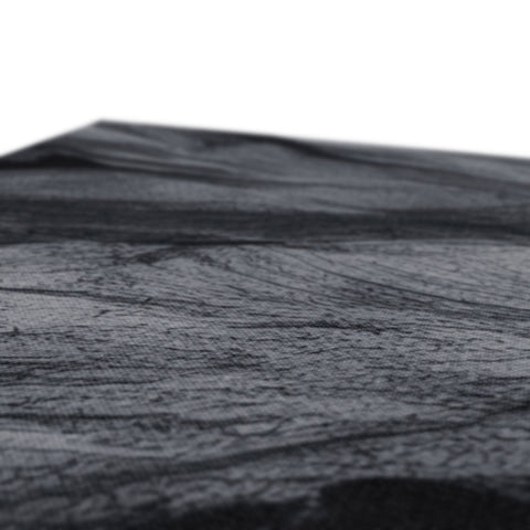 A piece of wood sitting on top of a table with a black and white background.