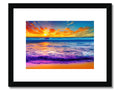 A colorful image on a small piece of paper framed in wood with a sunset over a