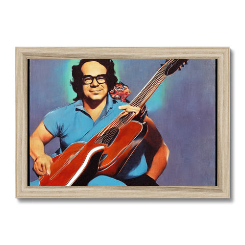 A photo of a man holding a red guitar on a wooden frame of a table at