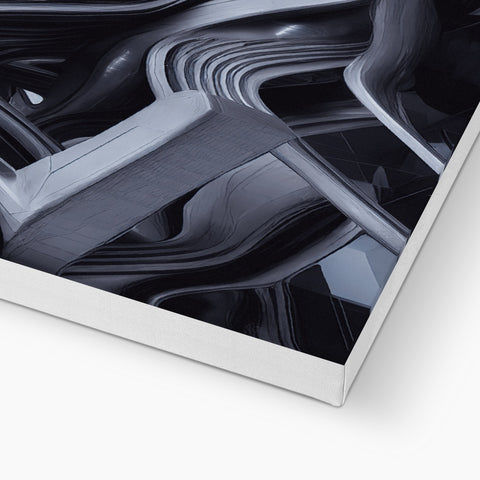 A silver and black art print of an abstract image is on a computer keyboard.