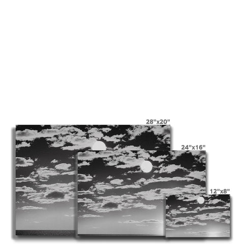 A group of plates with a picture of a view of a sky and mountains.