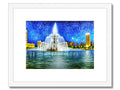 A picture of an art print of city skyscape near a fountain.