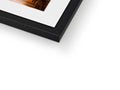 A wooden framed photo sits in a coffee table on top of a black frame.