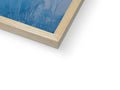 A picture frame made of wood is placed on a blue window sill.