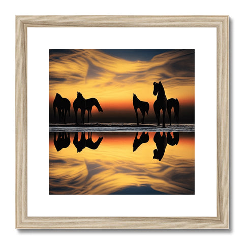 A golden framed picture of three horses riding the sides of a wood covered lake.