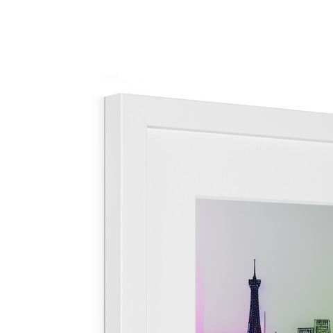 A picture frame next to a mirror is framed inside a white wall in a white room