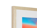 A picture frame has an image of a sunset on it.
