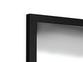 A television with a small mirror that leans back against a black wall.
