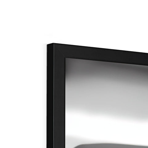 A television with a small mirror that leans back against a black wall.