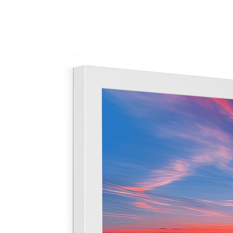 A screen that has a view of a colorful sunset sky.