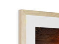 A fireplace framed in wooden wood with a frame to reflect the image.