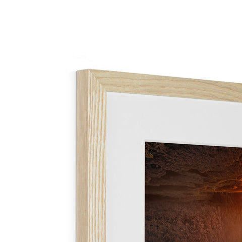 A fireplace framed in wooden wood with a frame to reflect the image.