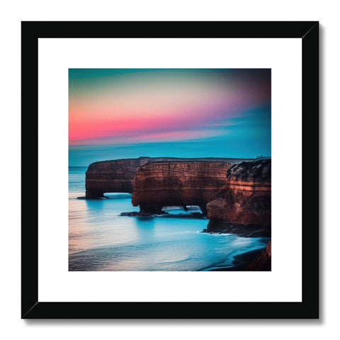 A framed photo of rocky coastline sitting on top of a shelf with ocean on the side