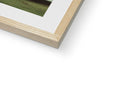 A picture frame for a white photograph attached to a table with wood frames.