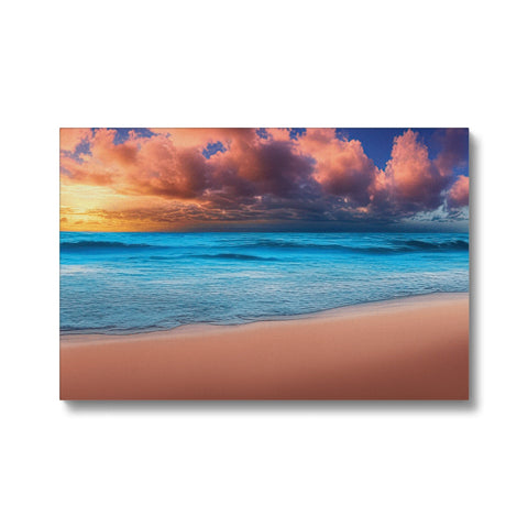 An art print laying on top of a beach by a beach with a colorful sky.