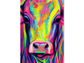 A cow standing next to a colorful print on a table.