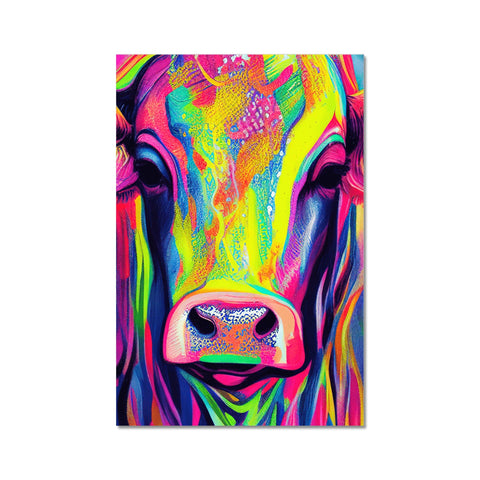 A cow standing next to a colorful print on a table.