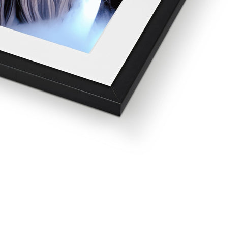 A picture frame on a white background, with black glasses and a photograph inside of a
