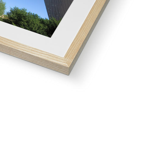 A picture of a closeup of a window with a large picture frame sitting on a