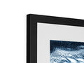 An art print on a large picture frame with a black background and black frame.