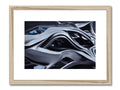 A framed art print of an abstract painting on a wooden background in a black frame.