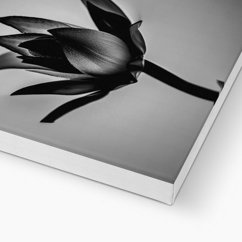 A dark book with a leather cover with a picture of flowers inside of it.