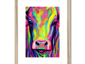 A white and black art print with a white cow on a wooden table.
