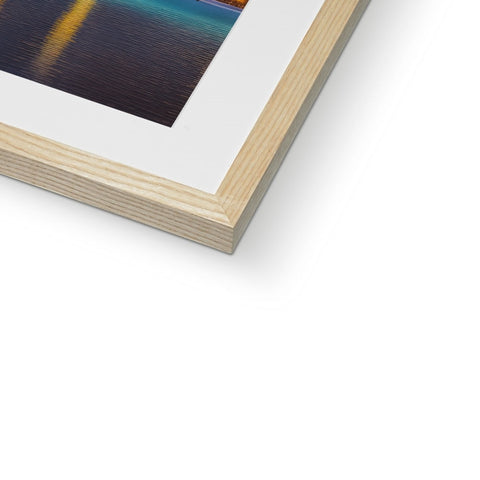 An art print wrapped in wood sitting on top of a white framed photo frame.