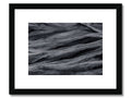 A wooden art print of ocean on a rocky, icy beach.
