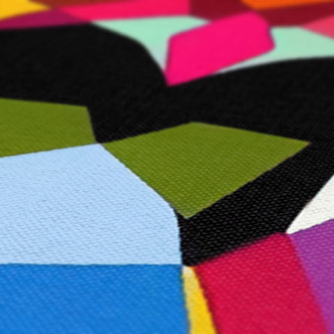 The fabric is laid out on a table covered in colorful cloths.
