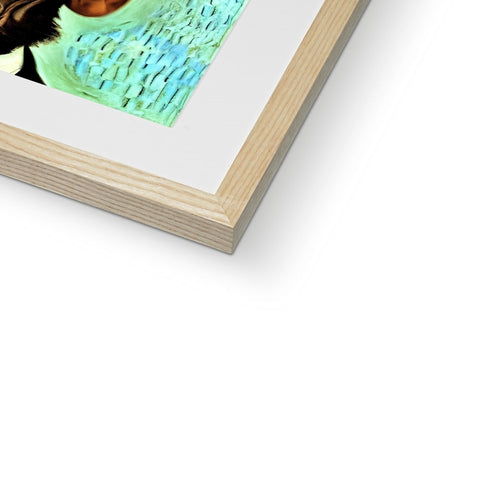 An artistic print on a picture frame sitting inside of a book on a floor.