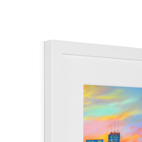 A picture frame holding some colorful artwork on top of a table with a picture on it