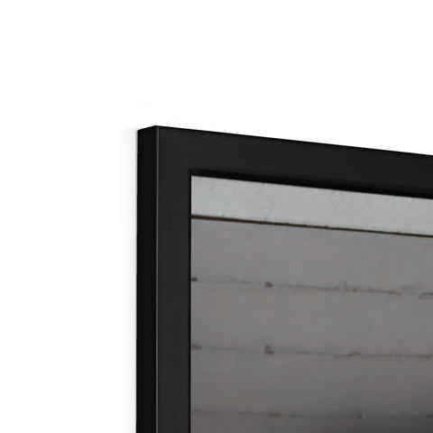 A picture frame sitting on a flat screen television display top of a wall