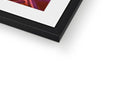 A colorful framed picture is in a small frame in the top of a tall wall.