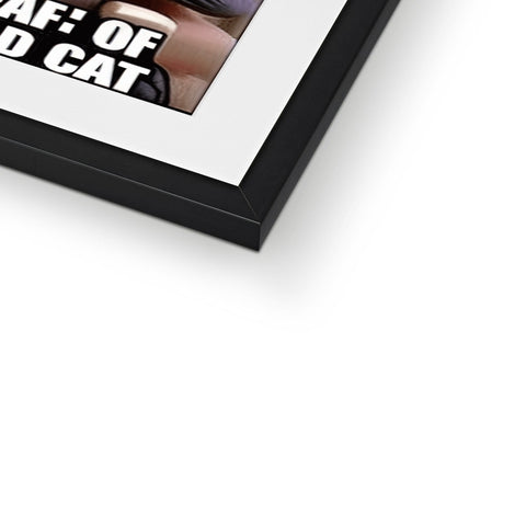 A cat in a small photograph on top of a picture frame with a catfood in