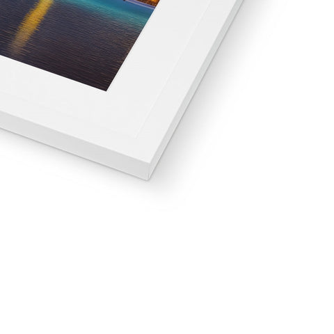 A white photo is placed on top of a photo frame with a blue and brown design