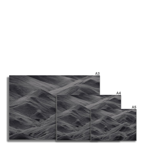 A wall with black and gray tile laying on top of a large rectangular pile of wood