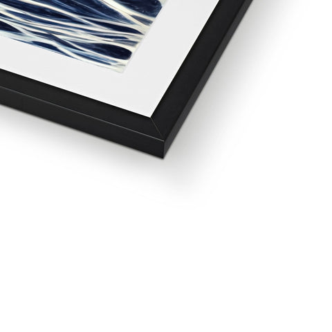 A framed photo of an abstract painting of a blue bird sitting on a top shelf.