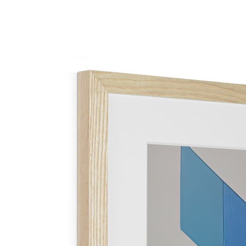 A frame that is on a shelf next to a small white piece of wood.